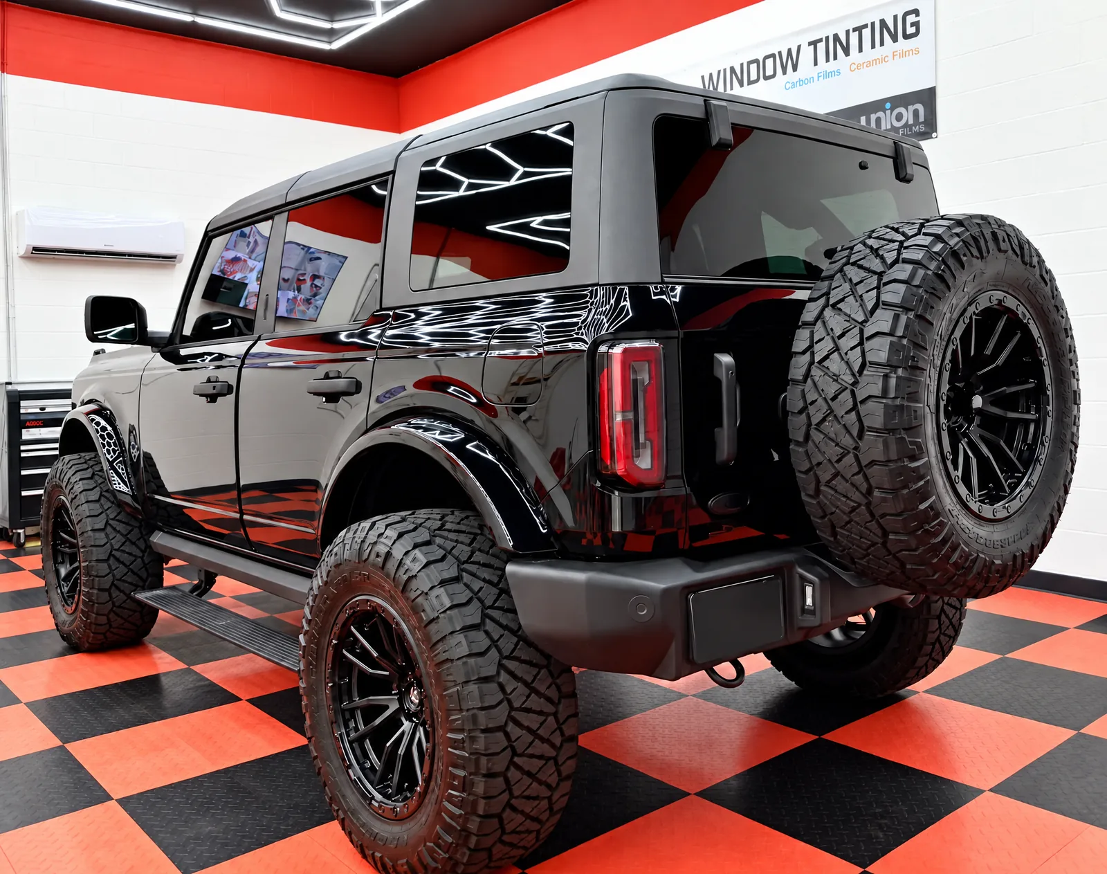 Black Ford Bronco with tinted windows in the Dynamic Tinting Solution shop in Largo, FL