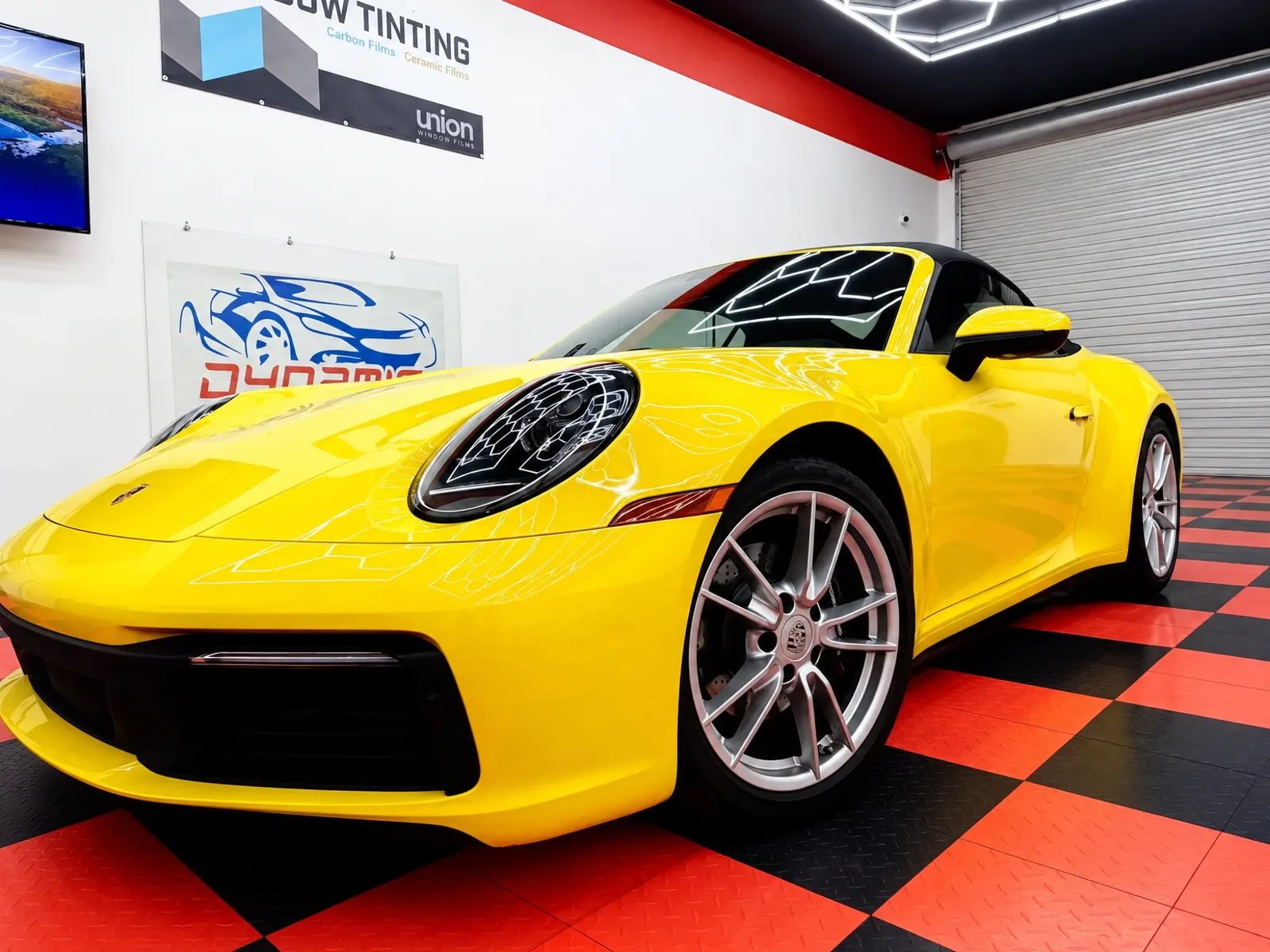 Yellow Porsche 911 in the Dynamic Tinting Solution shop in Largo, FL